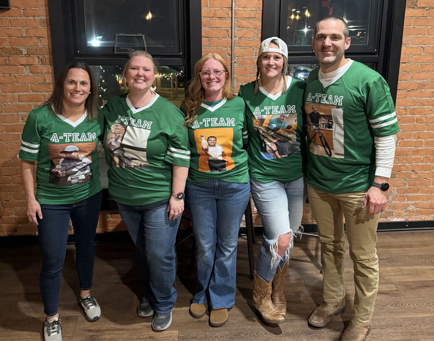 Meghan, Candas, Paige, Christine, and Dr. Andrews standing together in matching green A-Team jerseys